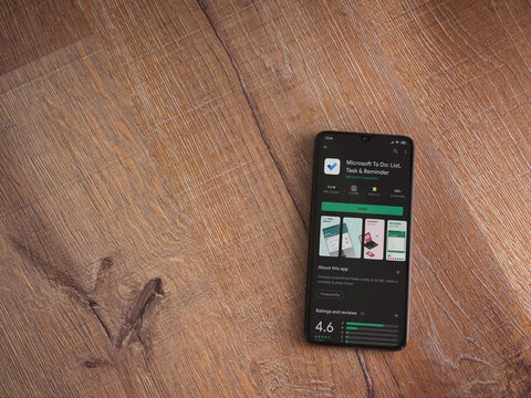 Lod, Israel - July 8, 2020: Microsoft To Do app play store page on the display of a black mobile smartphone on wooden background. Top view flat lay with copy space.