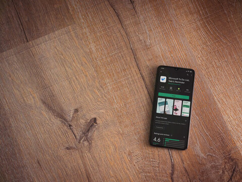 Lod, Israel - July 8, 2020: Microsoft To Do app play store page on the display of a black mobile smartphone on wooden background. Top view flat lay with copy space.