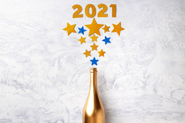 Champagne bottle with confetti flat lay top view