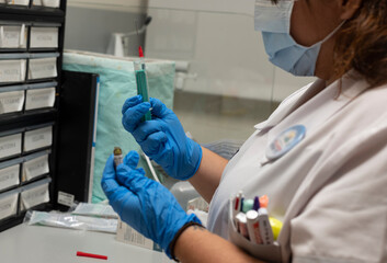 nurse carrying medication with a syringe