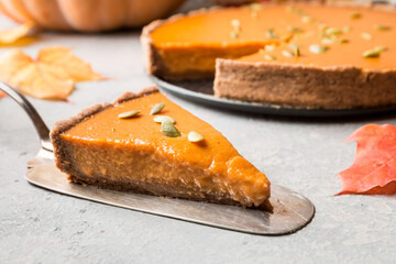 Piece of homemade Pumpkin Pie with Autumn Decoration