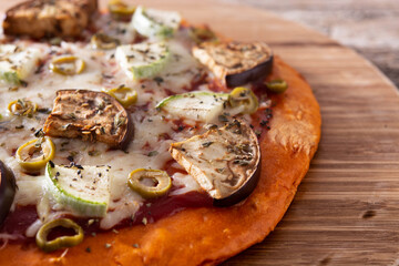 Autumn pumpkin pizza with vegetables on wooden table	