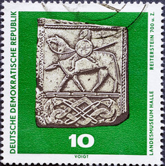 GERMANY, DDR - CIRCA 1970: a postage stamp from Germany, GDR showing a rider stone (around 700);...