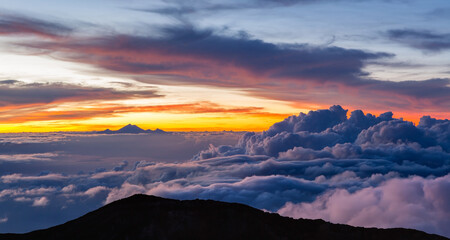 Fototapeta na wymiar Beautiful cloudscape with mt. Rinjani at horizon. View from mt. Agung at sunrise. Bali, Indonesia.