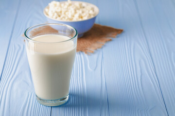 Glass of milk with bowl of cottage cheese