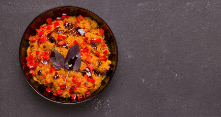 Vegetarian soy meat dish with vegetables and basil on a black background. Copy space