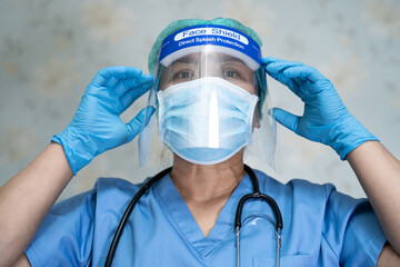 Asian doctor wearing face shield and PPE suit new normal to check patient protect safety infection...