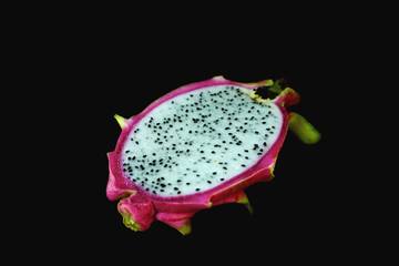 half of dragon fruit on the black background.