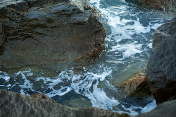 A piece of sea and stones, splashes, water, neutral background