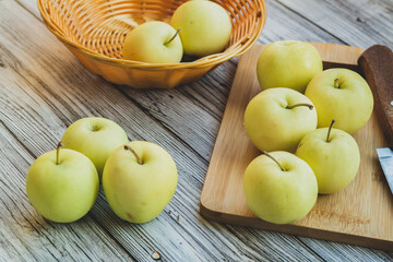 green apples on a light wooden background