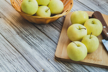 green apples on a light wooden background