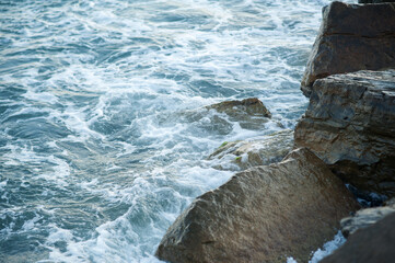 A piece of sea and stones, splashes, water, neutral background