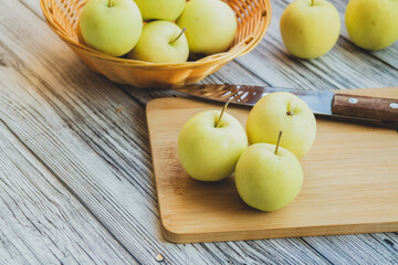 green apples on a light wooden background