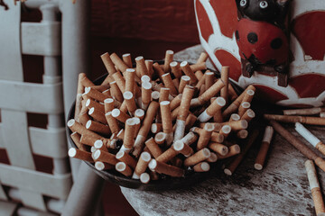 An ashtray filled with cigarette butts 