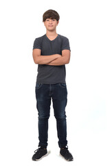 Naklejka premium portrait of a teenage boy on white background with crossed arms
