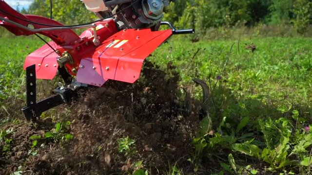 work with garden equipment, walk-behind tractor in slow mo