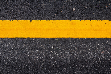Asphalt road surface with yellow line