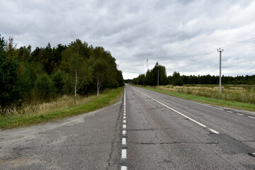 Fototapeta premium heavy clouds over a rural highway