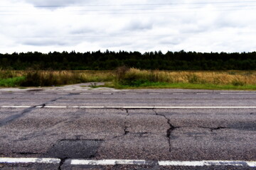 Fototapeta na wymiar cracked asphalt on a rural dorga
