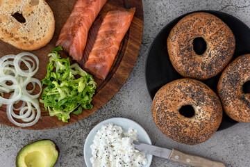 Ingredients for a salmon lox bagel arranged on a table