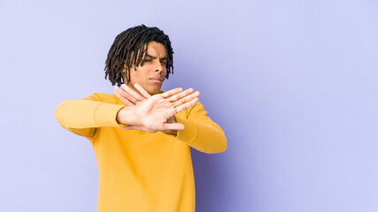 Young black man wearing rasta hairstyle doing a denial gesture