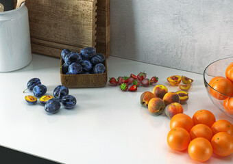 Marble worktop in kitchen with fruits, plums, strawberries, plums, oranges, peaches, , 3d illustration, 3d rendering	