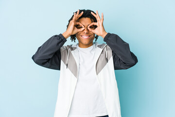 Young african american sport man showing okay sign over eyes