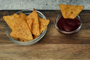 Corn cheese, snacks with sauce on a wooden stand. Beer snack, dish on the menu. Close up.
