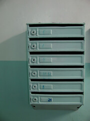 A row of mailboxes in an apartment building.