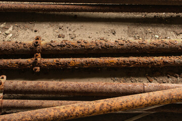 Rusted, corroded pipes on a concrete floor.