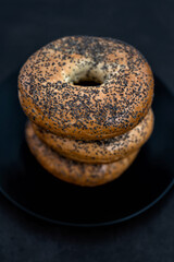Black plate full of Bagels on a Black Background