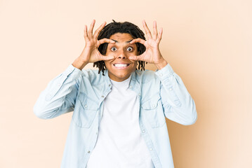 Young african american rasta man keeping eyes opened to find a success opportunity.