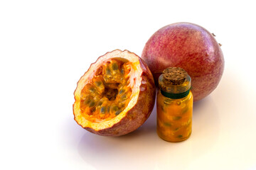 Maracuja cut in half in the bottle and flask and whole with leaf on wooden background. Passion...