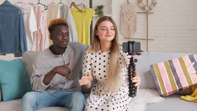 A Girl and Boy Takes Pictures of Themselves, Conducts a Blogging. A Bloggers Creating a New Content for Video Blog. Cute Lady and Young Man Shares the News With Her Followers during Vlogging.