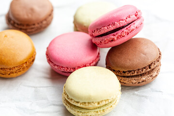 Chocolate, raspberry and Vanilla flavoured french macarons on white background