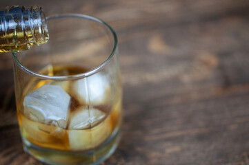 bottle of whiskey with a glass