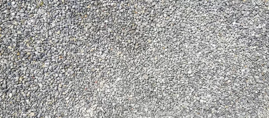 Poster texture of gravel stones on ground background © agrus