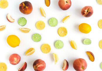 Fruit collage of slices of lemon, lime and peach on a white background. Summer frute background composition. Top view. Flat lay.