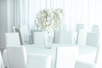 Empty restaurant luxury interior background. Empty chair and table inside room photo. White restaurant interior.