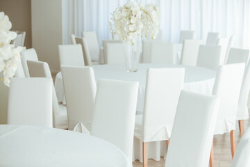 Empty restaurant luxury interior background. Empty chair and table inside room photo. White restaurant interior.