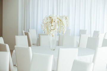 Empty restaurant luxury interior background. Empty chair and table inside room photo. White restaurant interior.