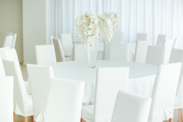 Empty restaurant luxury interior background. Empty chair and table inside room photo. White restaurant interior.
