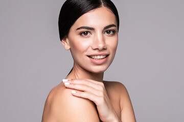 Young pretty woman with beauty skin isolated over gray background