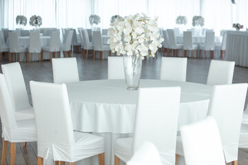 Empty restaurant luxury interior background. Empty chair and table inside room photo. White restaurant interior.