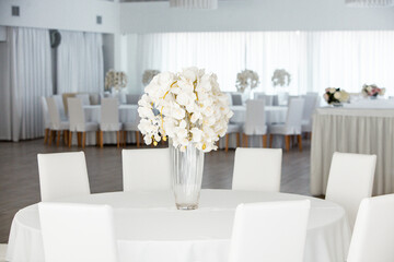 Empty restaurant luxury interior background. Empty chair and table inside room photo. White restaurant interior.