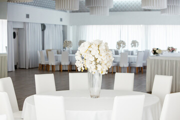 Empty restaurant luxury interior background. Empty chair and table inside room photo. White restaurant interior.