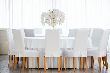 Empty restaurant luxury interior background. Empty chair and table inside room photo. White restaurant interior.