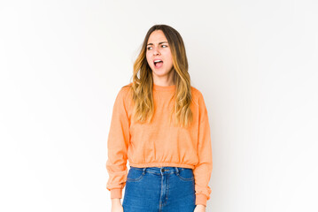 Young caucasian woman isolated on white background shouting very angry, rage concept, frustrated.