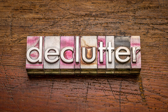 declutter word abstract in gritty vintage letterpress metal types against rustic weathered wood, business, lifestyle and personal development concept