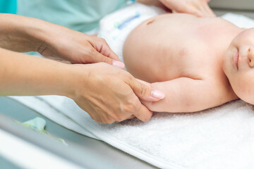 Fototapeta na wymiar Baby massage closeup. Mother and child. Newborn.